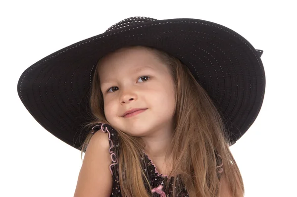 Cute smiling girl at the age of five in big black hat — Stock Photo, Image