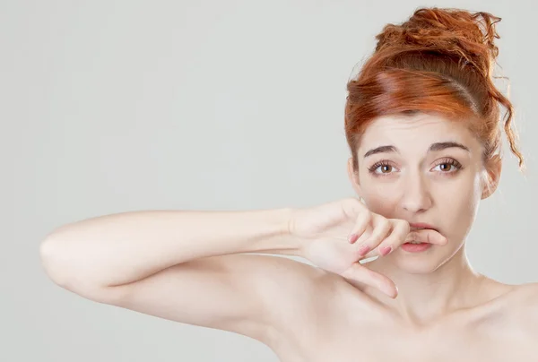 Red haired girl bites her finge — Stock Photo, Image