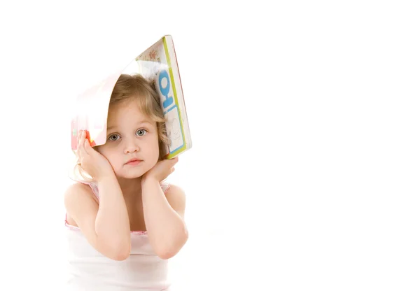 Quiet pretty little girl with book sitting on white background — Stock Photo, Image
