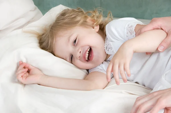 Adorable little girl resting in the bed — Stock Photo, Image