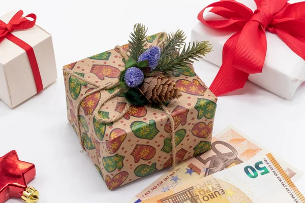 Hediye kutuları ve 50 avroluk parayla Noel arkaplanı. Kış tatiline hazırlık konsepti. Hediye alma zamanı. Kutlama düzeni