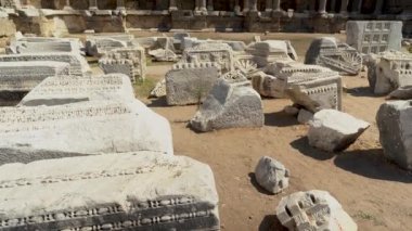 Tilt up shot of ruins or remains of columns at Devlet Agorasi in Side, Turkey. 4K footage, Beautiful old archeological park
