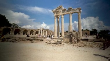 Side, Turkey - September 11, 2021: A tourist girl using photo for photography against temple ruins of Apollo in the Ancient city of Side in Antalya province of Turkey