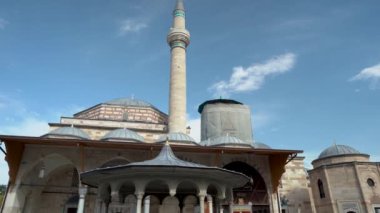Konya, Turkey - September 11, 2021: Wide angle shot of one of the famous mevlana museum and mosque of Konya and people visiting to pray