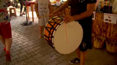 Antalya, Turkey - September 11, 2021: Traditional Turkish dancers dance by tourists to drum instrument, Group of people enjoying to a turkish music, culture art fun and dance activity concept