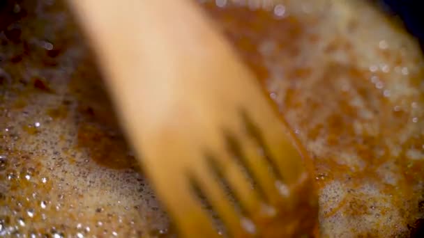 Slow Motion Wooden Stick Mixing Heated Melted Caramel Sugar Syrup — Stock Video