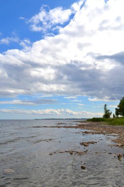 Great Lakes 'teki Rocky kıyı şeridi. Kireçtaşı rafı arka planda güzel mavi gökyüzü olan kaba bir plaj oluşturuyor. Green Bay 'in Michigan Gölü suları Menomine Michigan John Henes Parkı' nda. Door County ile ilkbahar geldi..