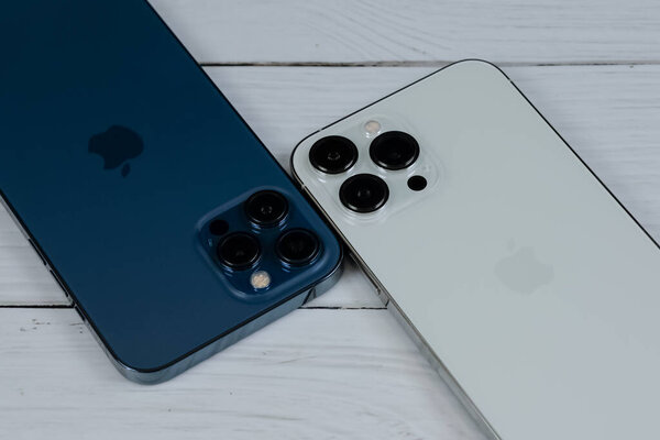 iPhone 13 Pro Max in Silver and iPhone 12 Pro Max in Pacific Blue