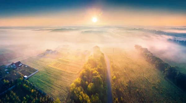 stock image First sunlight glowing foogy valley. Beautiful morning scene of Ukrainian countryside. Colorful ladscape of cultivated fields. Spectacular sunrise on Ternopil, Ukraine. 