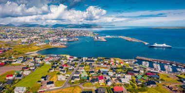 Panoramic summer view from flying drone of Torshavn town. Aerial morning scene of Streymoy island, Faroe, Denmark, Europe. Traveling concept background. clipart