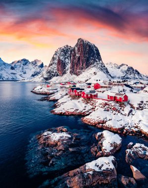 Popüler turizm beldesi Hamnoy limanında Festhaeltinden Mount arka planda, Norveç. Lofoten Adaları 'nın renkli akşam manzarası. Norveç denizinin görkemli kışın deniz manzarası.
