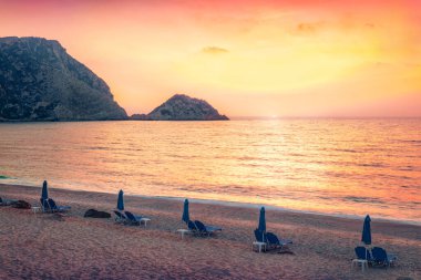 Sunset on the seaside. Wonderful summer view of Petani Beach. Romantic evening landscape of Cephalonia Island, Greece, Europe. Colorful seascape of Mediterranen Sea, Ionian Islands. clipart