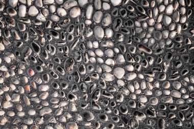 Background of small stones on the road. Rough surface of small pebble stone.