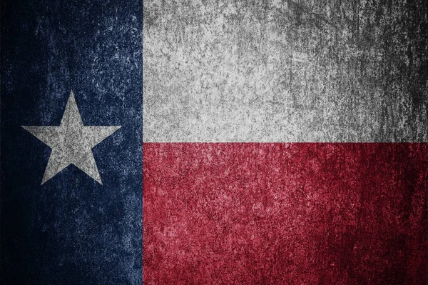 Closeup of grunge Texas flag. Dirty Texas flag on a metal surface.