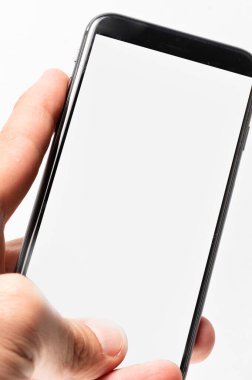 Man hand using smartphone on white background. Closeup shot of man hand holding a smartphone. Vertical image