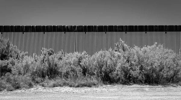 A dirt road runs along a section of the US-Mexico border wall near Fabens, Texas and east of El Paso.