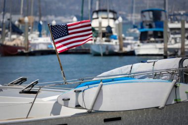 An American flag blows in the wind on a sailboat at Glorietta Bay in Coronado, California.