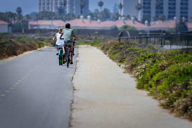 A family of bikers on a summer ride on the Silver Strand near Coronado, California.