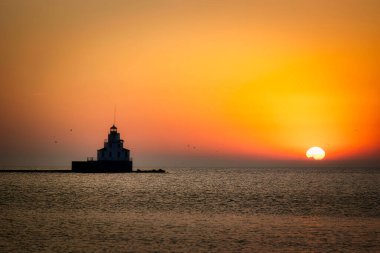 A summer sunrise on the Lake Michigan harbor of Manitowoc, Wisconsin.