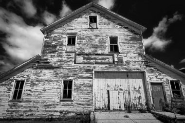 The summer sun warms an abandoned building that stands in Cleveland, Wisconsin.
