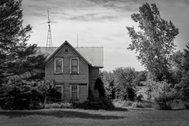 An abandoned farm house stands next to the road in Kossuth, near Manitowoc, Wisconsin.
