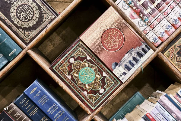 Bookshelf with religious books on Islam in different languages. — Stock Photo, Image