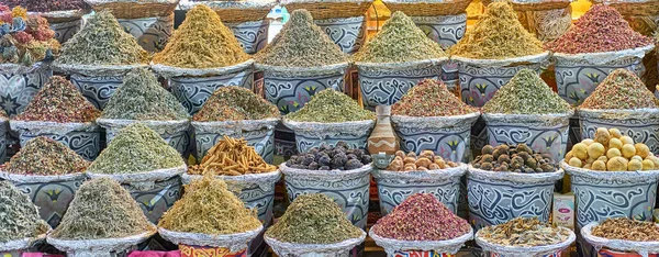 Mezclas secas de hierbas y bayas para hacer té, especias orientales en cestas en el mercado callejero nocturno. — Foto de Stock