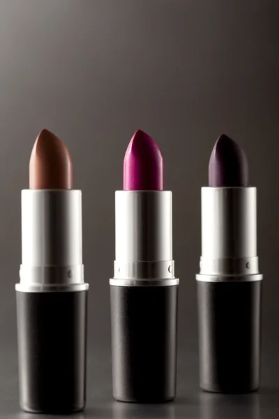 Lipsticks on dark background — Stock Photo, Image