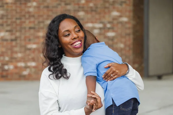 Красивая афро-американская мама обнимает своего маленького сына — стоковое фото