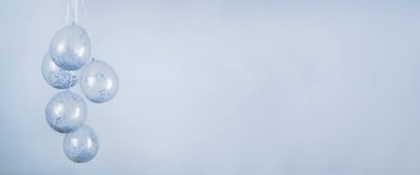 A monochromatic blue confetti clear balloons against a light beige backdrop for a banner with copy space.