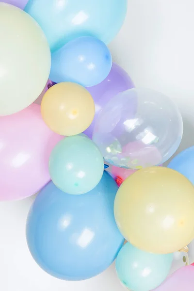 A close up image of a soft pastel balloon garland against a white background.