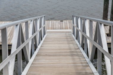 The steep walkway going down to a boat launch pier.