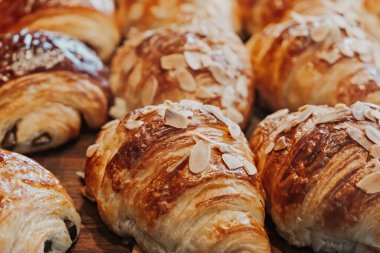 Fresh almond and chocolate croissants at a bakery.