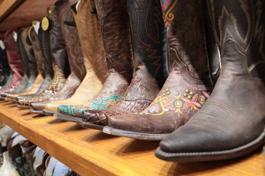 A long row of cowboy boots on sale at a store in Texas.
