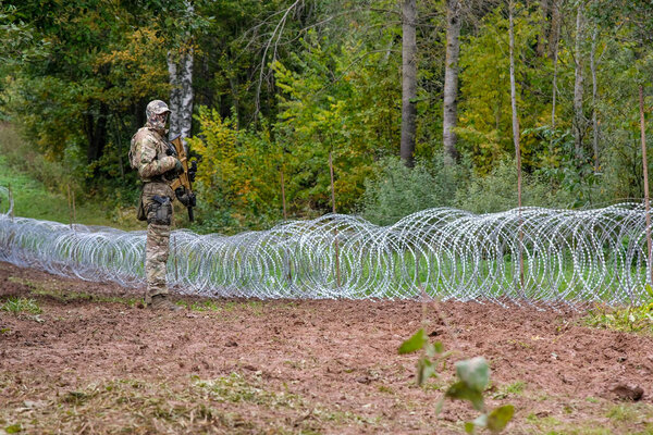 Indra, Latvia - September 28, 2021: Latvia - Belarus border, where Latvian State Border Guard and army begins to install a barbed wire fence