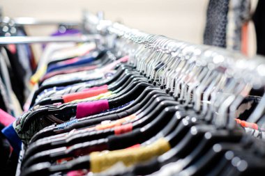 İkinci el giysi mağazası. Askılarda eski giysiler var. Odaklanmamış