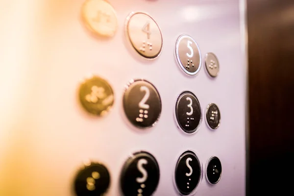 Interior and closeup of metal buttons in elevator. Level 5 is highlighted. Selective focus. High quality photo
