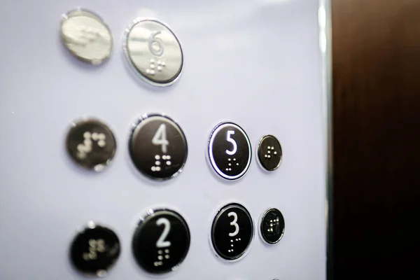 Interior and closeup of metal buttons in elevator. Level 5 is highlighted. Selective focus. High quality photo