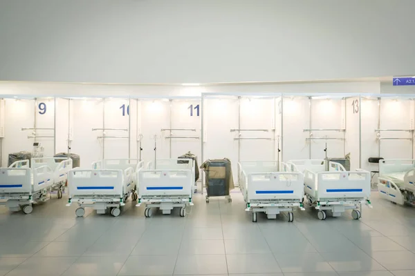 Several empty hospital beds in the hospital. The hospital is preparing for an influx of patients. Covid-19 pandemic. Defocused. High quality photo