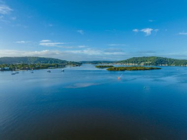 Sabah deniz manzarası ışık bulutu ve dağ zeminleri ile Orta Sahildeki Woy Woy, NSW, Avustralya.