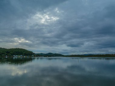 Aerial sunrise waterscape with rain clouds at Woy Woy on the Central Coast, NSW, Australia.