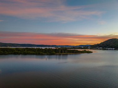 Orta Sahildeki Woy Woy, NSW, Avustralya 'da yüksek bulutlu ve yumuşak pastel renklere sahip hava gündoğumu su manzarası..