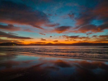 Umina Point 'te, Umina Sahili' nde, NSW 'de, Avustralya' da, Umina Sahili 'nde, renkli yüksek bulutlarla kumsalda gün doğumu..