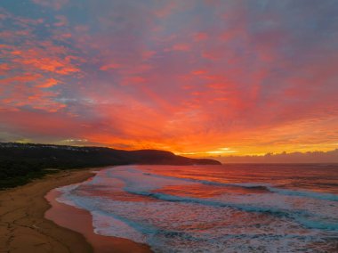 Sunrise seascape with colourful cloud covered sky at Killcare Beach on the Central Coast, NSW, Australia.