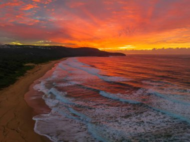 Sunrise seascape with colourful cloud covered sky at Killcare Beach on the Central Coast, NSW, Australia.