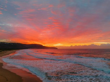 Sunrise seascape with colourful cloud covered sky at Killcare Beach on the Central Coast, NSW, Australia.
