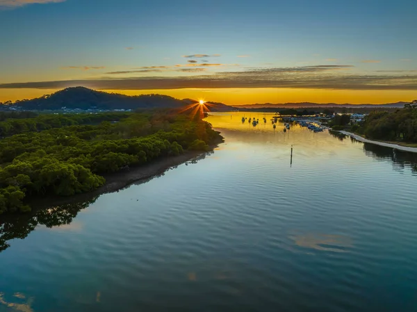 Aerial sunrise over the bay with high cloud at Woy Woy on the Central Coast, NSW, Australia.