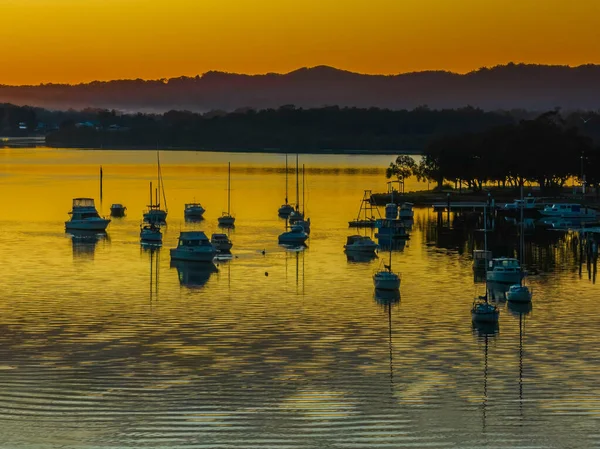 Aerial sunrise over the bay with boats at Woy Woy on the Central Coast, NSW, Australia.