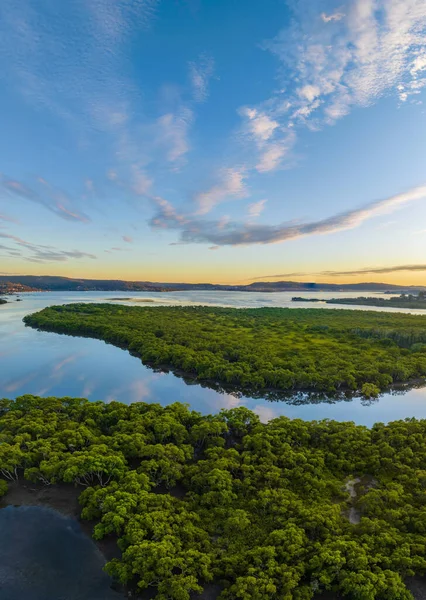 Aerial sunrise over the bay with high cloud at Woy Woy on the Central Coast, NSW, Australia.