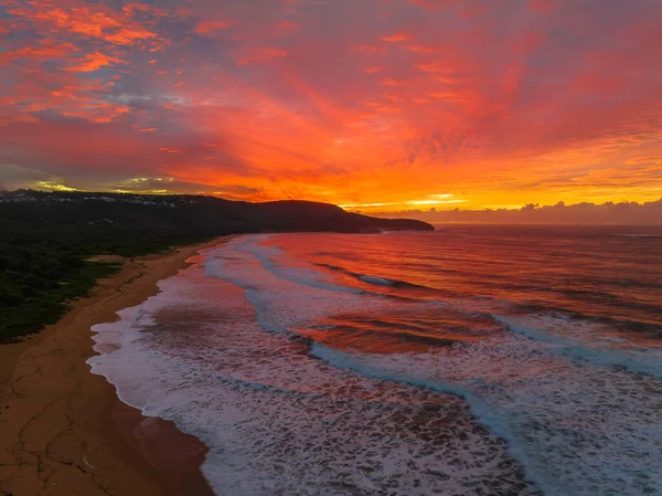 Sunrise seascape with colourful cloud covered sky at Killcare Beach on the Central Coast, NSW, Australia.